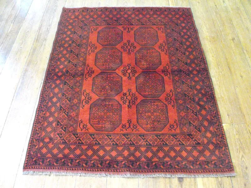 A Hardy Red Afghan Rug: 193cm x 150cm